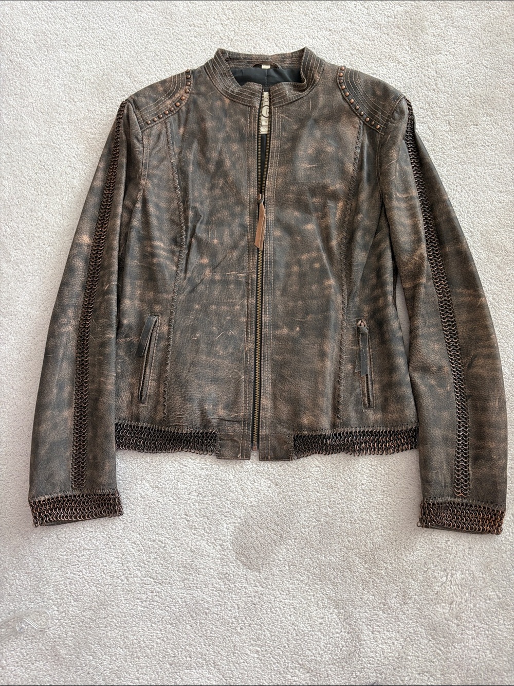Brown Distressed Leather Jacket with Decorative Stitching, and Chain Accents.